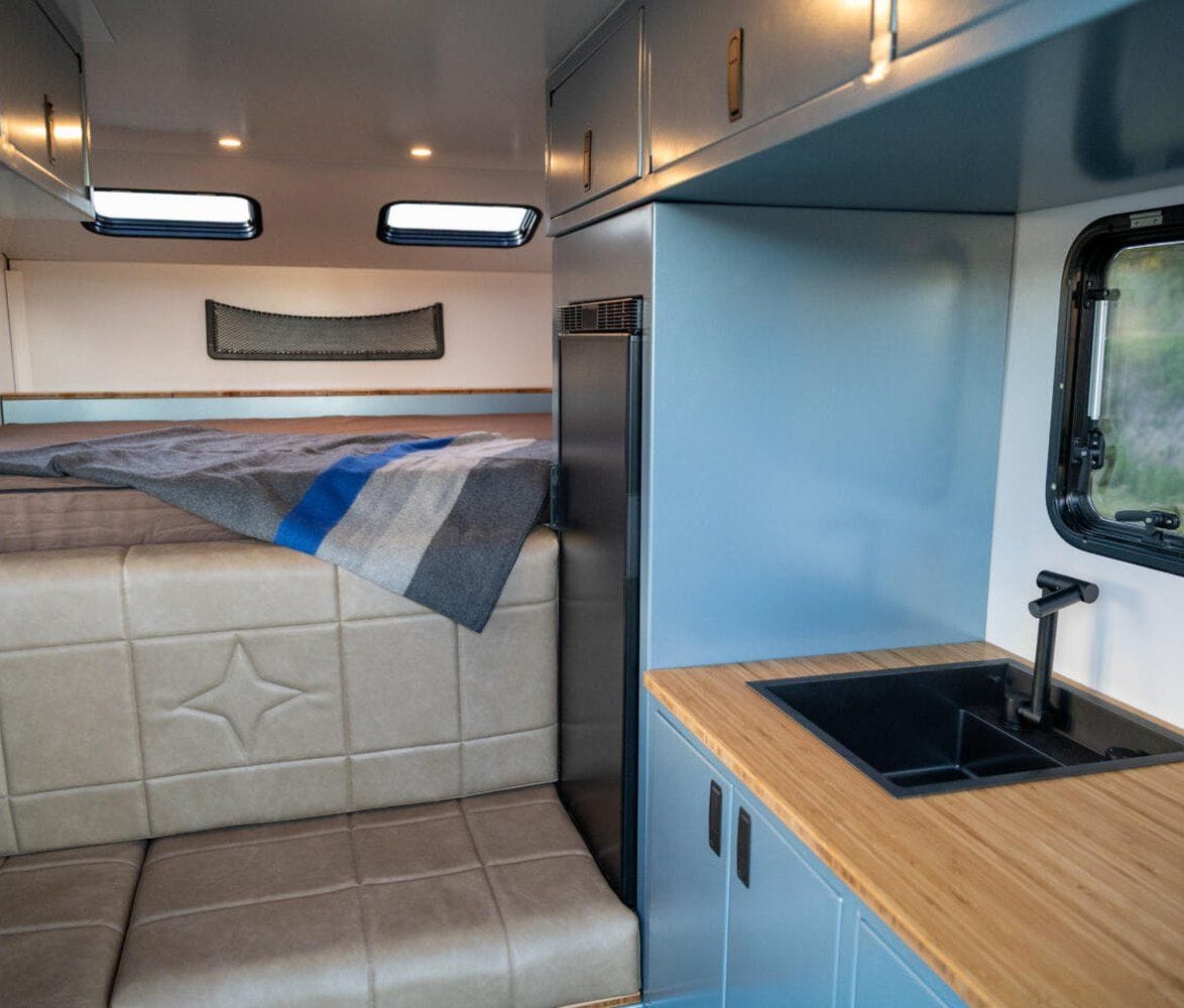 alaskan-hs-640-composite-pickup-camper-10-interior-kitchen-and-sleeping-area-1174x1000.jpg | Image
